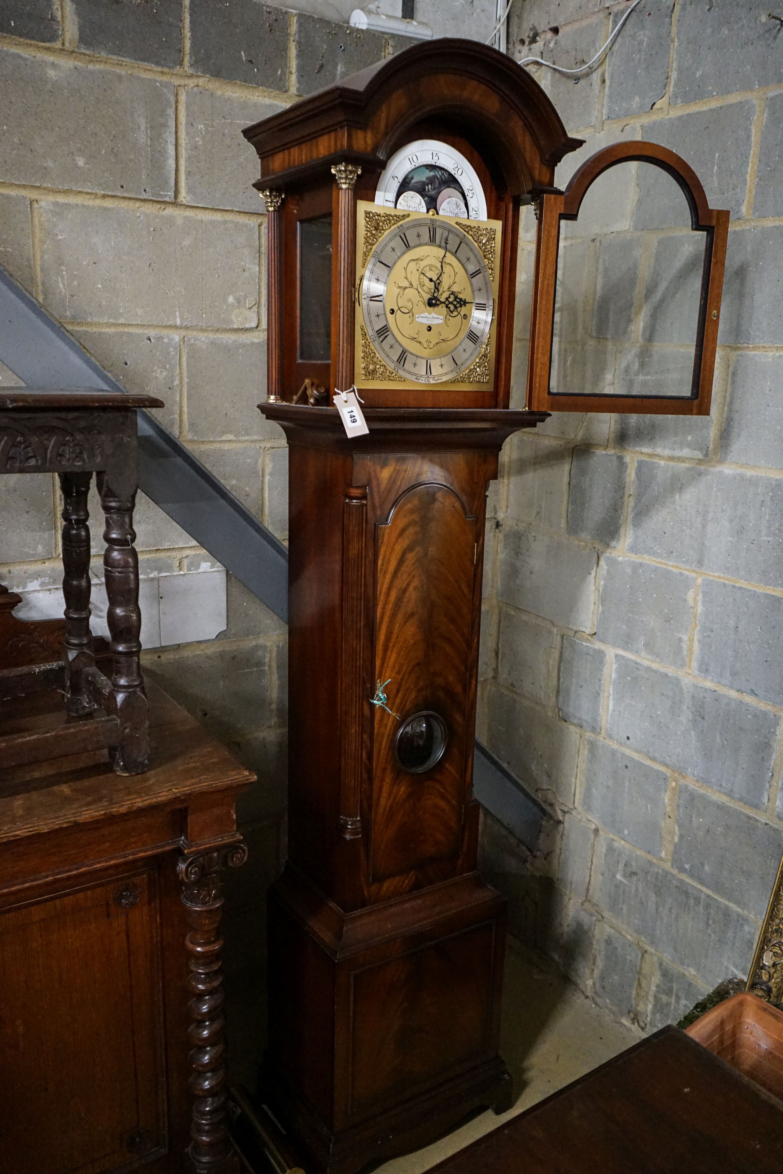 A modern mahogany longcase clock by Comitti London eight day, striking and chiming movement, brass dial with rocking ship automaton, the case with bulls-eye door, height 203cm
